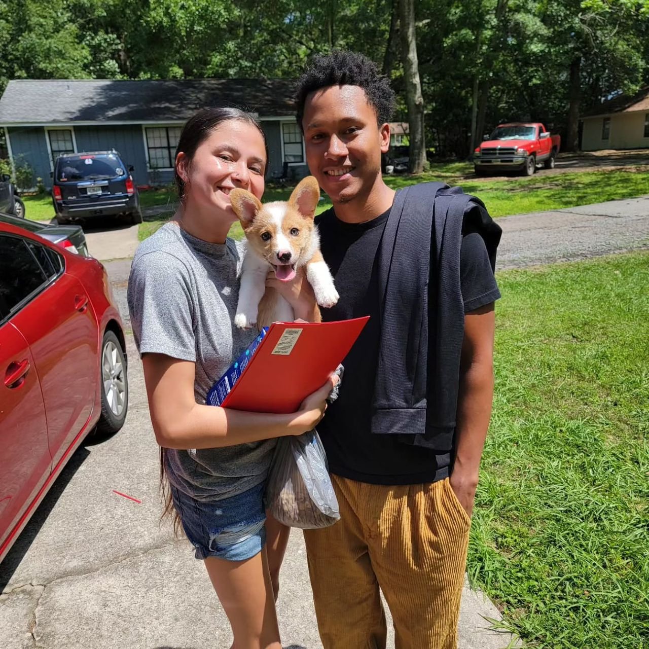Family with energetic Corgi in backyard